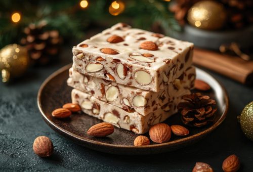 Traditional Spanish turrón bars with almonds served on ceramic plate surrounded by holiday decorations, fir twigs, and golden ornaments in a festive sweet setup with copy space